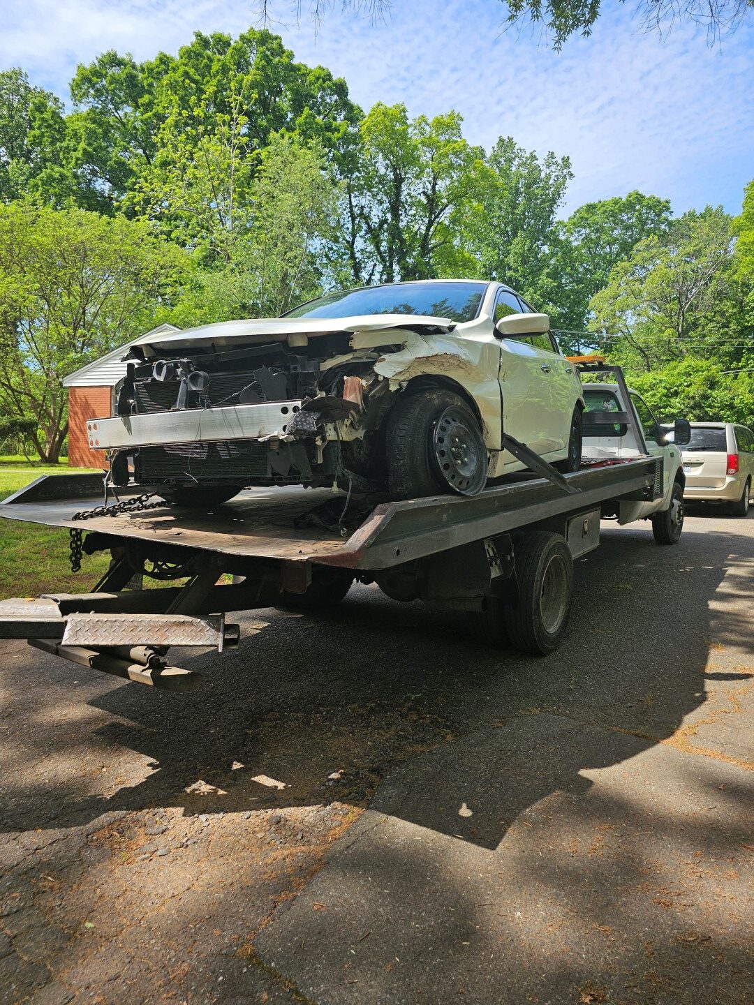 junk car on tow-truck bed